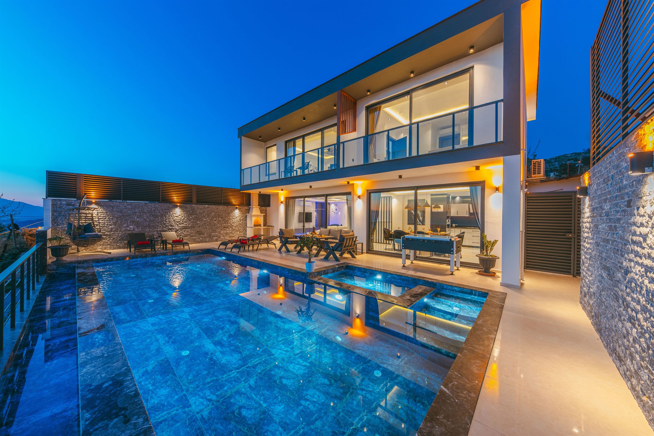 Villa Aurelia facade and pool glowing at blue hour