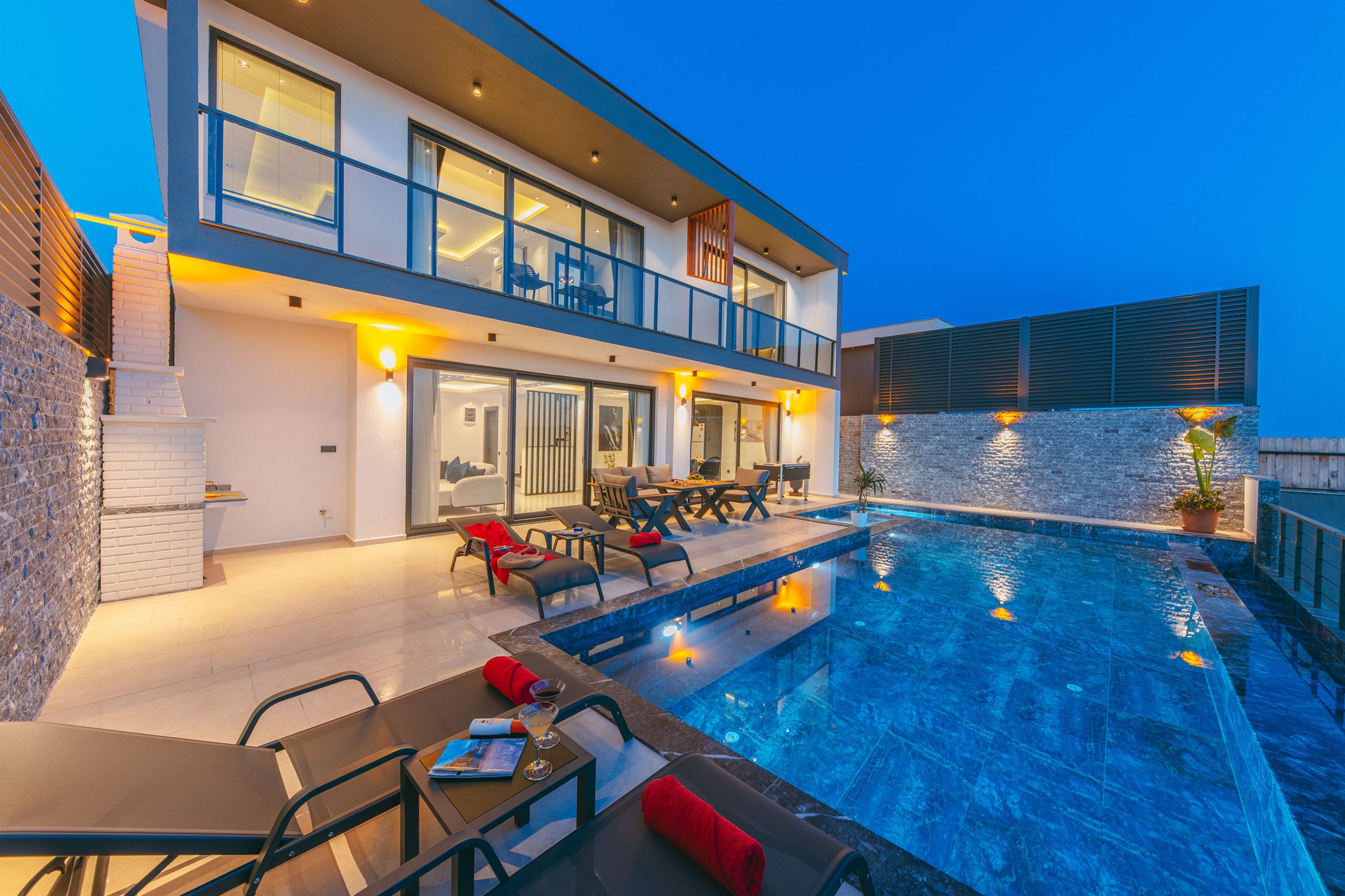 Real Villa Aurelia exterior and pool illuminated at blue hour