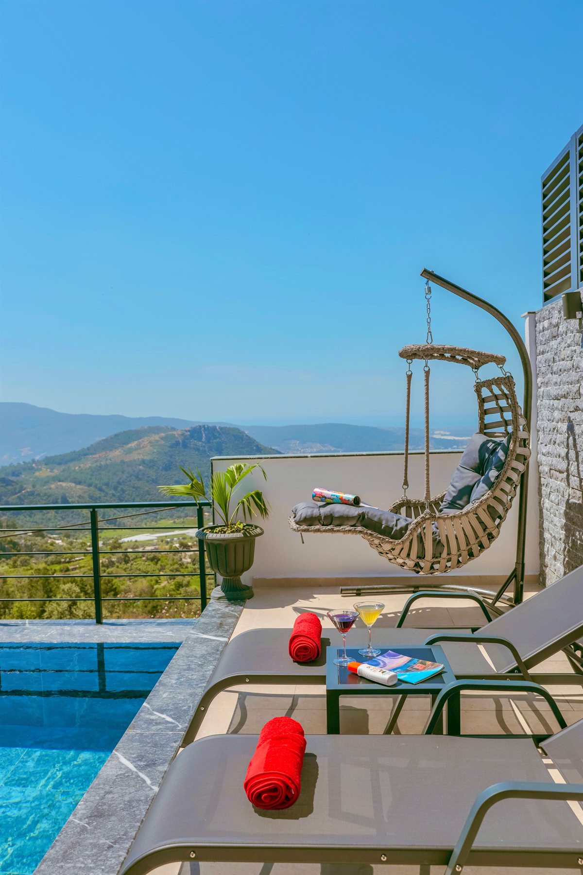 Pool terrace with loungers and panoramic hills at Villa Aurelia